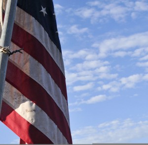 Handwritten_notes_cover_a_U_S__flag_set_up_outside_the_rubble_of_Briarwood_Elementary_School_in_Moore,_Okla_,_May_22,_2013_130522-F-YU985-728